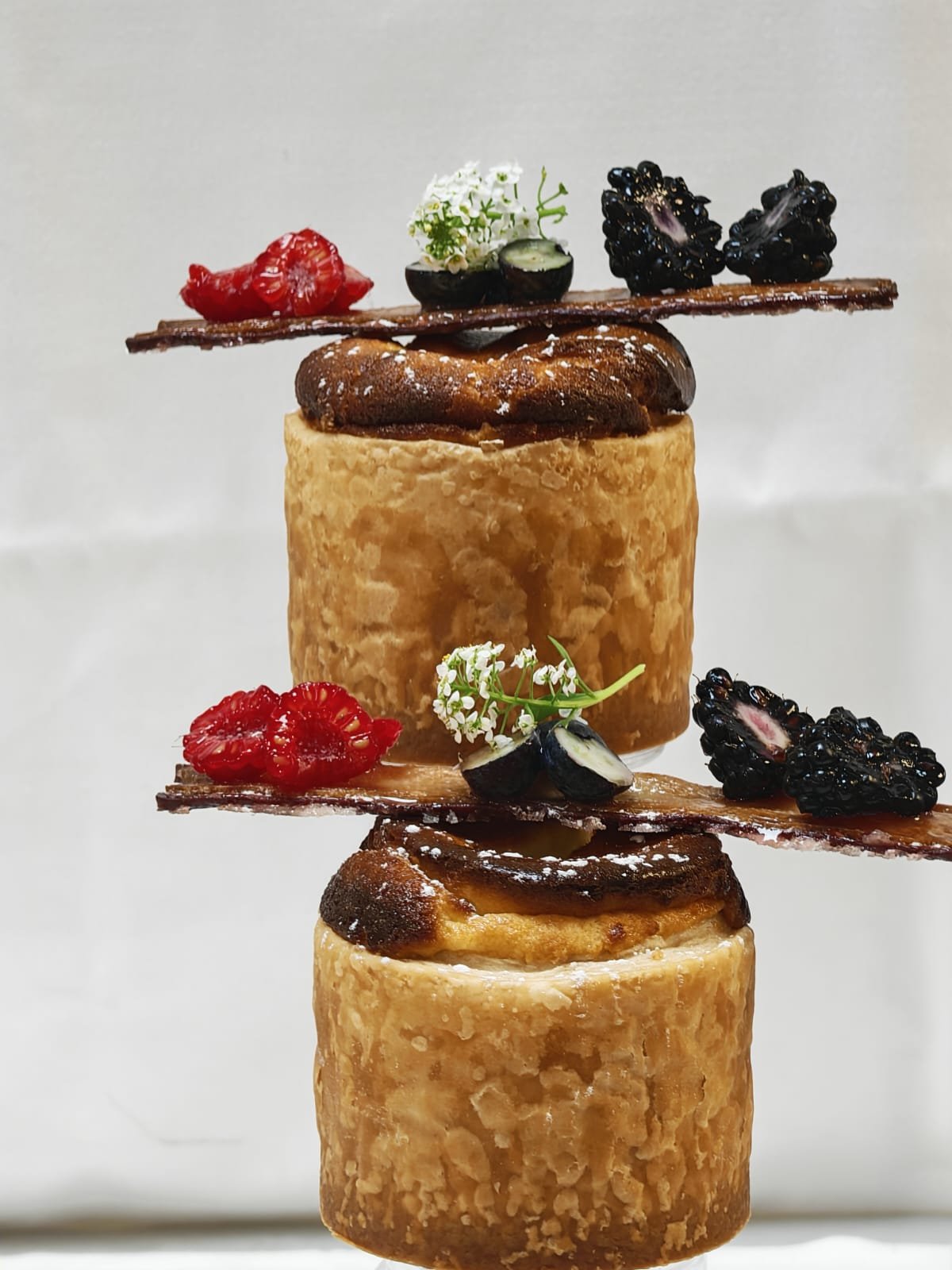 Round laminated bakery products with fruit garnish
